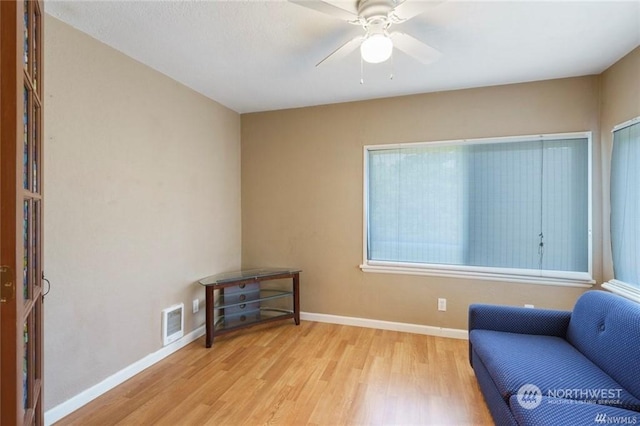 sitting room with ceiling fan and light hardwood / wood-style floors