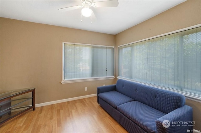 sitting room with light hardwood / wood-style floors and ceiling fan