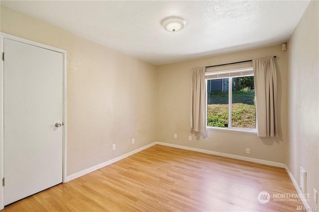 unfurnished room with light hardwood / wood-style floors