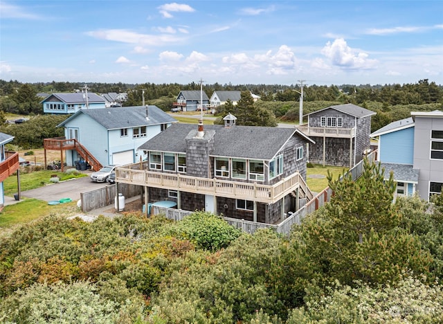 rear view of property featuring a balcony