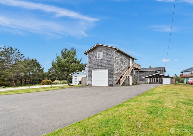 exterior space with a garage and a lawn