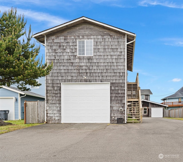 exterior space featuring a garage and an outdoor structure