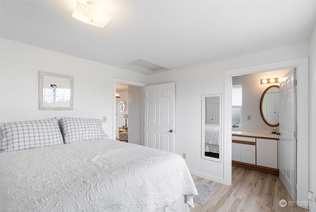 bedroom featuring sink and light hardwood / wood-style floors