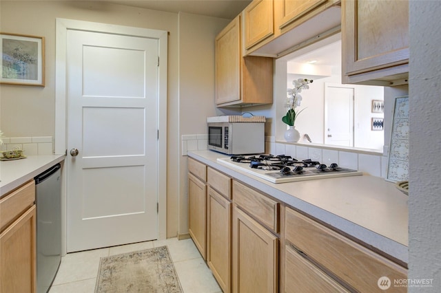 kitchen featuring white appliances, light brown cabinets, light tile patterned floors, and light countertops