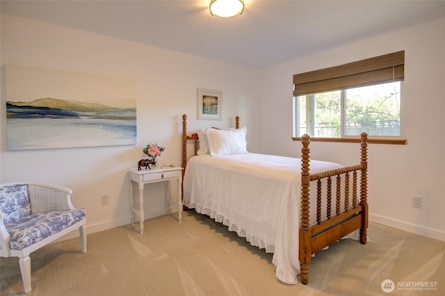 bedroom with baseboards and light carpet