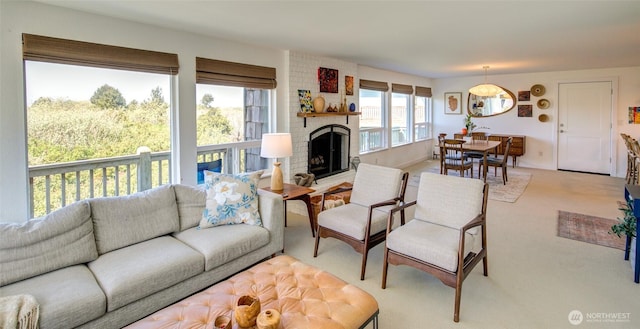 living area featuring light colored carpet and a fireplace