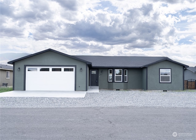 ranch-style home featuring a garage