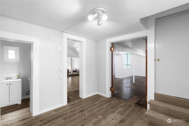 corridor with sink and dark hardwood / wood-style floors