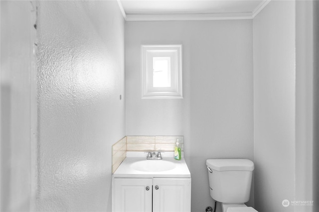 bathroom featuring vanity, toilet, and ornamental molding