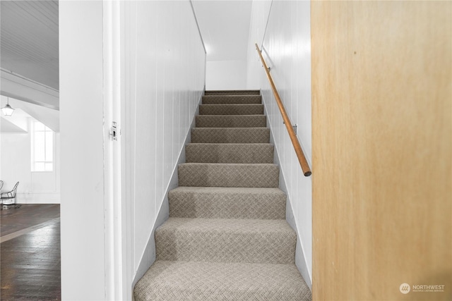 staircase featuring wood-type flooring