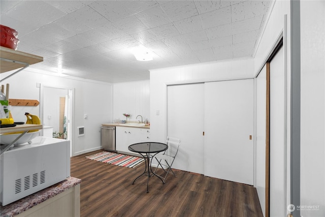 interior space with crown molding, sink, and dark hardwood / wood-style floors