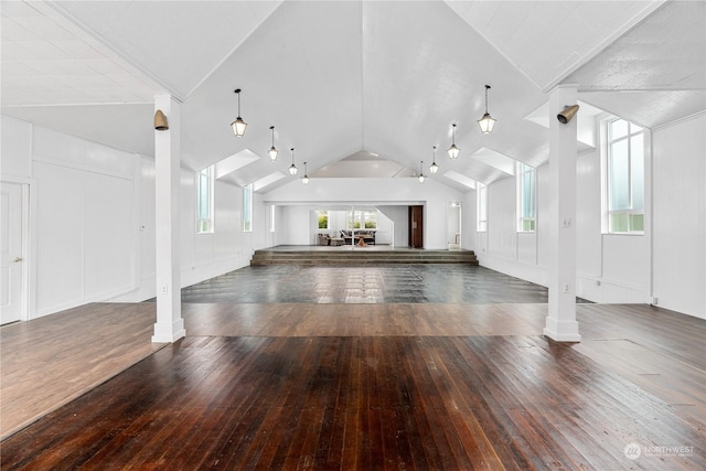 unfurnished living room featuring dark hardwood / wood-style floors and vaulted ceiling