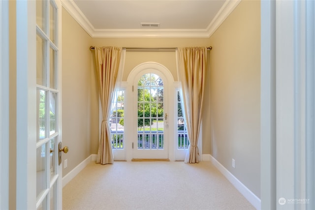 doorway to outside with crown molding, french doors, and carpet