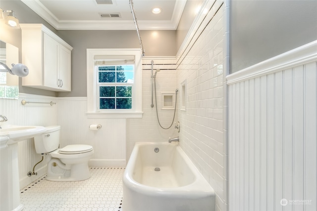 bathroom featuring toilet, tile patterned flooring, tiled shower / bath combo, and ornamental molding