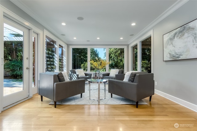 living room with crown molding and light hardwood / wood-style floors