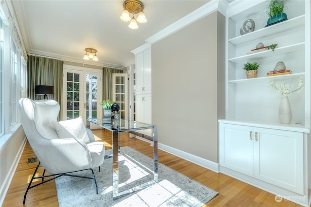 interior space with built in features, light hardwood / wood-style flooring, french doors, and ornamental molding