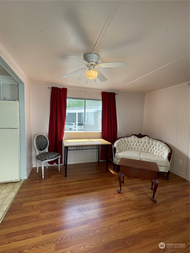 living area with ceiling fan and wood-type flooring