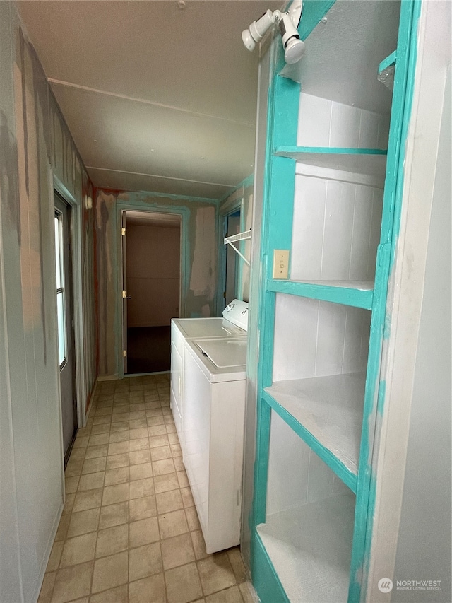 clothes washing area featuring washer and dryer and light tile patterned floors