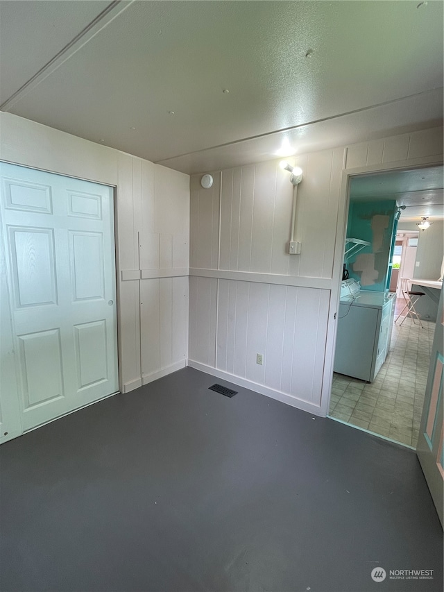 interior space with concrete flooring and washer and dryer