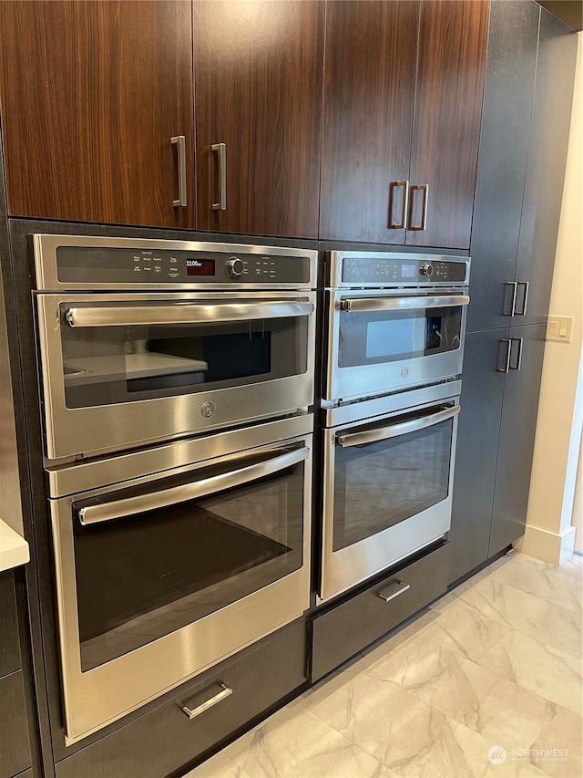 kitchen featuring double oven and dark brown cabinetry