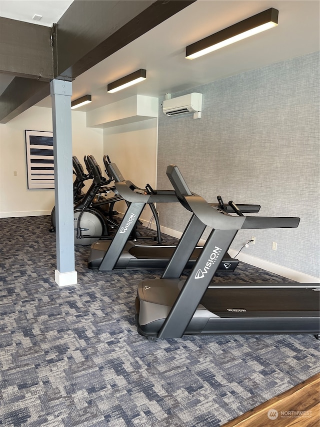 workout area featuring dark hardwood / wood-style flooring and a wall mounted AC