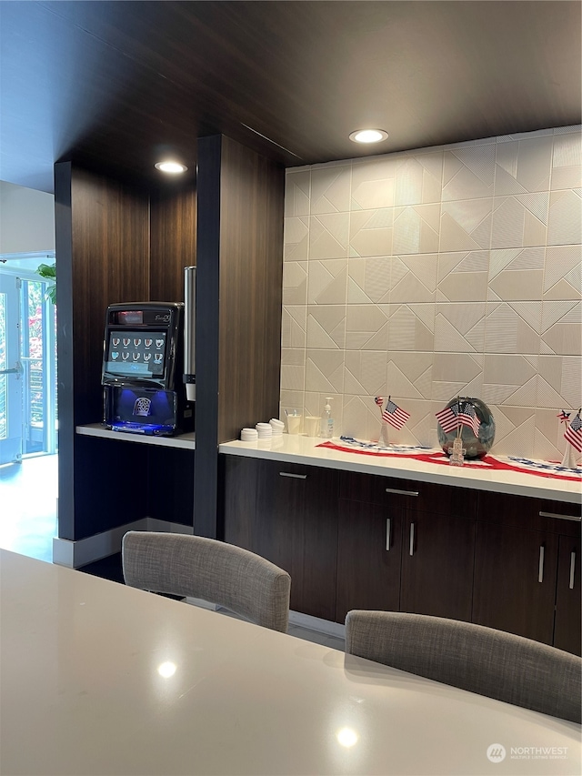 kitchen with dark brown cabinets and backsplash