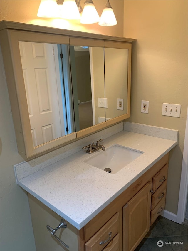 bathroom featuring tile patterned flooring and vanity