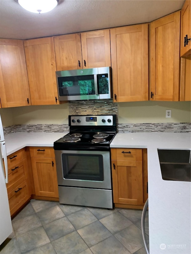 14150 SE 17th Pl Unit B-8, Bellevue, WA 98007 - kitchen with appliances with stainless steel finishes, light countertops, and decorative backsplash