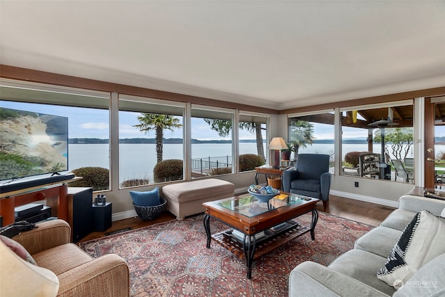 living room featuring a water view and wood-type flooring