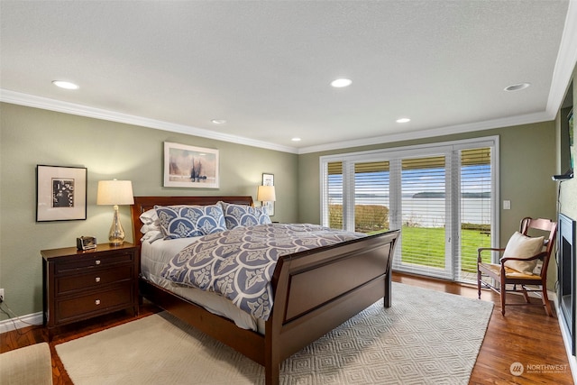 bedroom featuring access to exterior, light hardwood / wood-style flooring, and ornamental molding