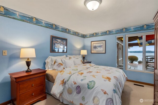 carpeted bedroom featuring access to outside and a water view