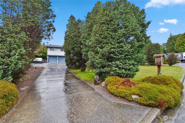 view of front of home with a garage and a front lawn