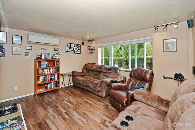 living room featuring hardwood / wood-style flooring and a wall mounted AC