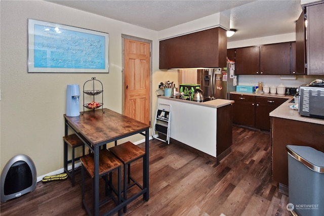 kitchen with stainless steel fridge, dark hardwood / wood-style floors, dark brown cabinets, and black electric cooktop