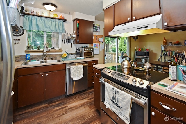 kitchen featuring stainless steel appliances, dark hardwood / wood-style floors, a healthy amount of sunlight, and sink