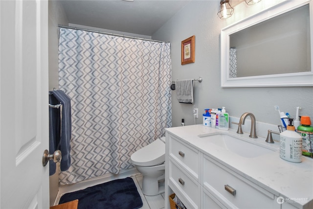 bathroom featuring tile patterned flooring, vanity, and toilet