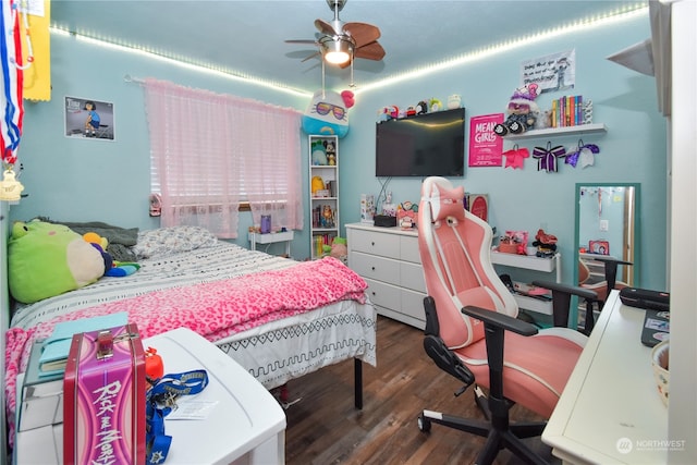 bedroom with dark hardwood / wood-style flooring and ceiling fan