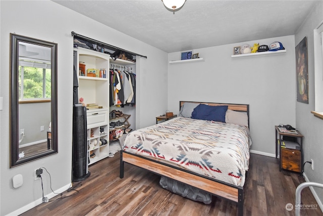 bedroom featuring dark hardwood / wood-style floors and a closet