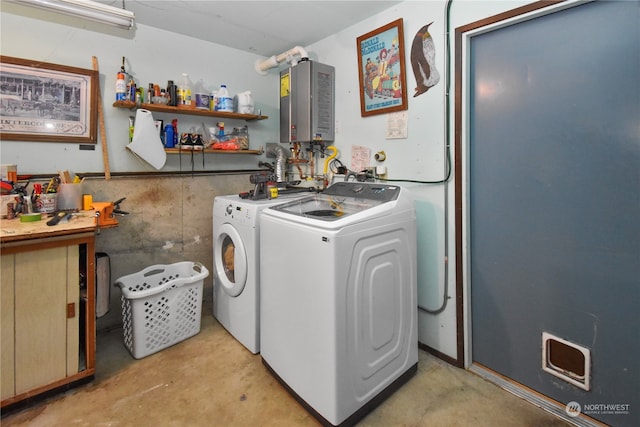 laundry area with water heater and washer and clothes dryer