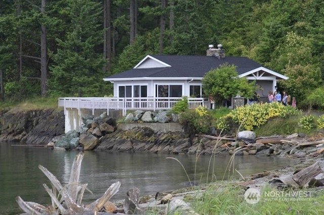 back of house featuring a deck with water view