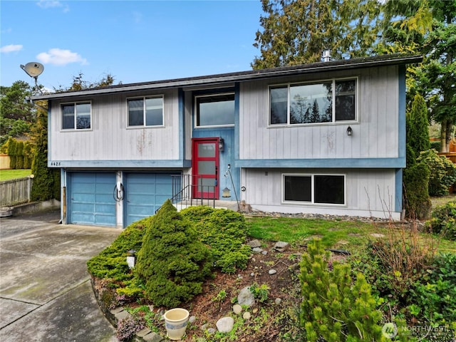 split foyer home featuring a garage and concrete driveway