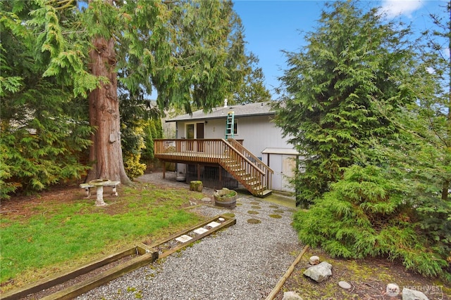 back of house with a deck and stairs