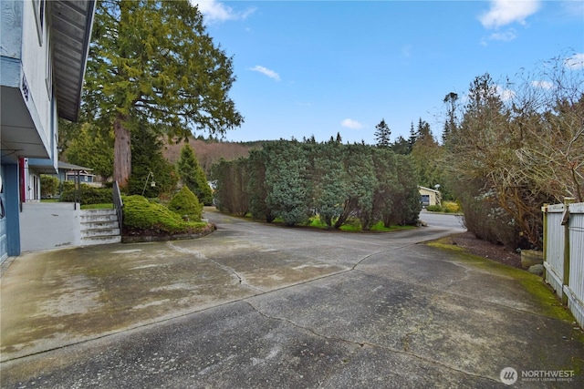 view of street featuring concrete driveway