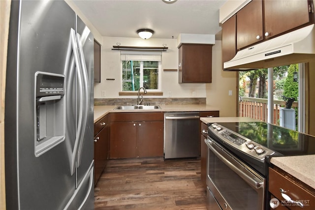 kitchen featuring a wealth of natural light, appliances with stainless steel finishes, light countertops, and a sink