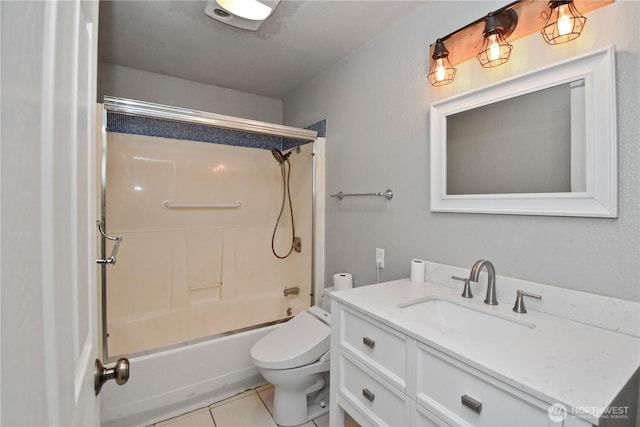 full bath featuring  shower combination, vanity, toilet, and tile patterned floors