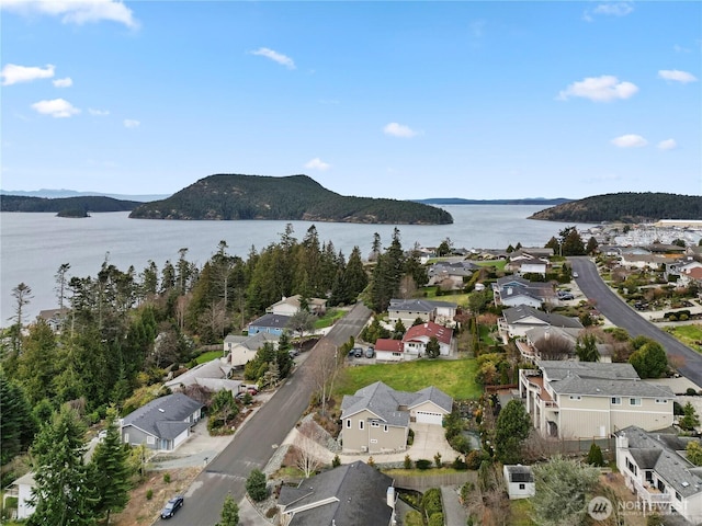 birds eye view of property with a residential view and a water and mountain view