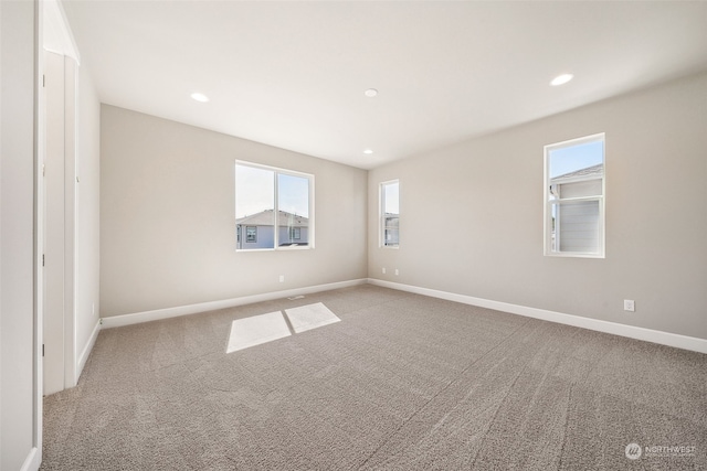 carpeted spare room with recessed lighting and baseboards