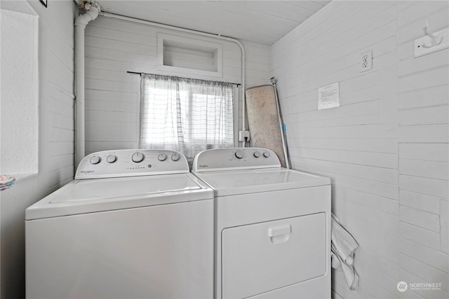 clothes washing area featuring washer and clothes dryer