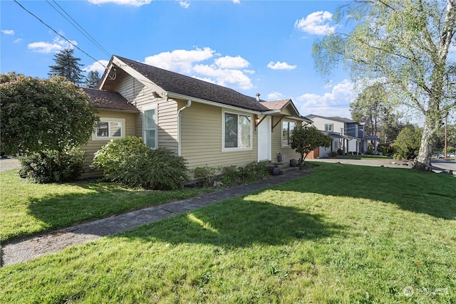 view of side of home with a lawn