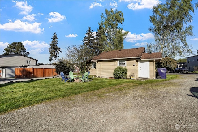 exterior space with a yard and an outdoor fire pit